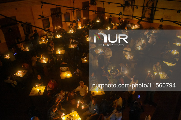 People light candles in solidarity with the victim of rape and murder at RG Kar Medical College, as seen at the iconic India Coffee House in...