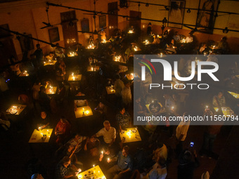 People light candles in solidarity with the victim of rape and murder at RG Kar Medical College, as seen at the iconic India Coffee House in...