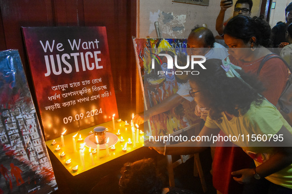 People light candles in solidarity with the victim of rape and murder at RG Kar Medical College, as seen at the iconic India Coffee House in...