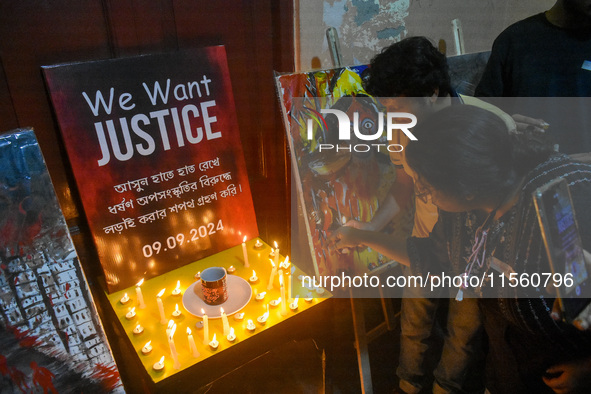 People light candles in solidarity with the victim of rape and murder at RG Kar Medical College, as seen at the iconic India Coffee House in...