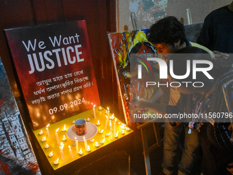 People light candles in solidarity with the victim of rape and murder at RG Kar Medical College, as seen at the iconic India Coffee House in...