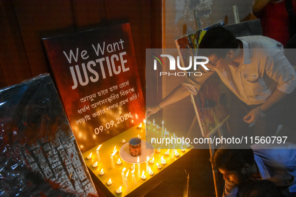 People light candles in solidarity with the victim of rape and murder at RG Kar Medical College, as seen at the iconic India Coffee House in...