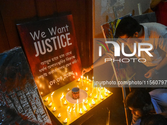 People light candles in solidarity with the victim of rape and murder at RG Kar Medical College, as seen at the iconic India Coffee House in...