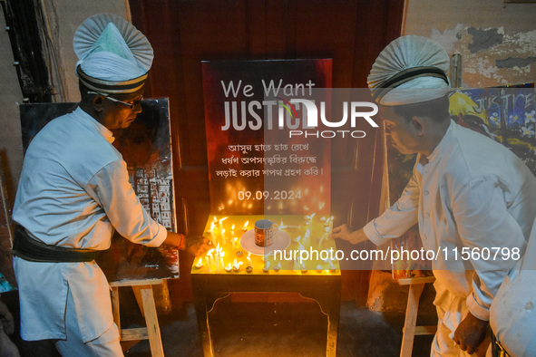 Servers light candles in solidarity with the victim of rape and murder at RG Kar Medical College, as seen at the iconic India Coffee House i...