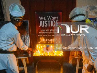 Servers light candles in solidarity with the victim of rape and murder at RG Kar Medical College, as seen at the iconic India Coffee House i...