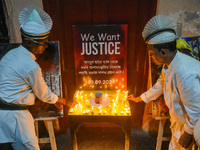 Servers light candles in solidarity with the victim of rape and murder at RG Kar Medical College, as seen at the iconic India Coffee House i...