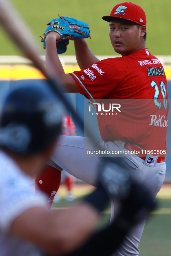 Tomohiro Anraku #20 of Diablos Rojos pitches the ball during the Resumption of the 2024 King Series match 3 against Sultanes de Monterrey of...