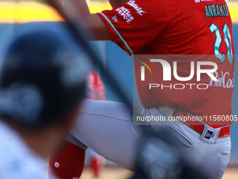 Tomohiro Anraku #20 of Diablos Rojos pitches the ball during the Resumption of the 2024 King Series match 3 against Sultanes de Monterrey of...