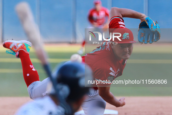 Tomohiro Anraku #20 of Diablos Rojos pitches the ball during the Resumption of the 2024 King Series match 3 against Sultanes de Monterrey of...