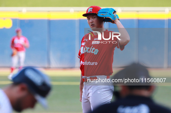 Tomohiro Anraku #20 of Diablos Rojos pitches the ball during the Resumption of the 2024 King Series match 3 against Sultanes de Monterrey of...