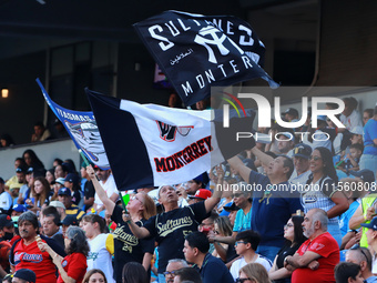 Sultanes de Monterrey fans wave their team flags during the resumption of the 2024 King Series match 3 of the Mexican Baseball League (LMB)...