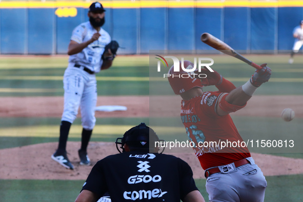 Jose Marmolejos #46 of Diablos Rojos hits the ball during the Resumption of the 2024 King Series match 3 against Sultanes de Monterrey of th...