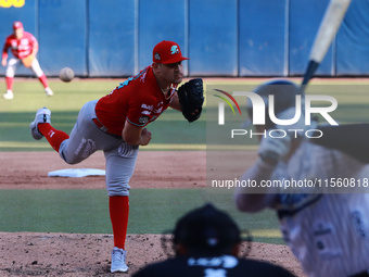 Edwin Fierro #58 of Diablos Rojos pitches the ball during the resumption of the 2024 King Series match 3 against Sultanes de Monterrey of th...