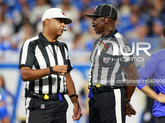 DETROIT,MICHIGAN-SEPTEMBER 8:  Referee Adrian Hill (29) talks with umpire Roy Ellison (81) during a game between the Detroit Lions and the L...