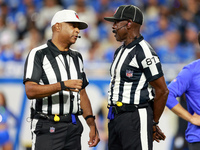 DETROIT,MICHIGAN-SEPTEMBER 8:  Referee Adrian Hill (29) talks with umpire Roy Ellison (81) during a game between the Detroit Lions and the L...