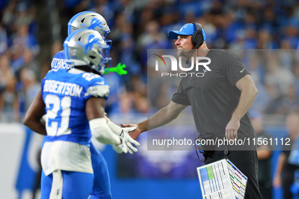 DETROIT,MICHIGAN-SEPTEMBER 8:  Detroit Lions head coach Dan Campbell congratulates defensive end Aidan Hutchinson (97) of the Detroit Lions...