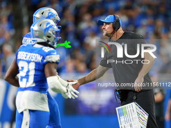 DETROIT,MICHIGAN-SEPTEMBER 8:  Detroit Lions head coach Dan Campbell congratulates defensive end Aidan Hutchinson (97) of the Detroit Lions...