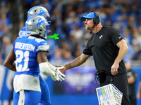 DETROIT,MICHIGAN-SEPTEMBER 8:  Detroit Lions head coach Dan Campbell congratulates defensive end Aidan Hutchinson (97) of the Detroit Lions...