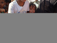 Displaced Palestinian children wait at a food distribution point in Deir el-Balah, Gaza Strip, on September 9, 2024, amid the ongoing confli...