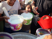 Displaced Palestinian children wait at a food distribution point in Deir el-Balah, Gaza Strip, on September 9, 2024, amid the ongoing confli...