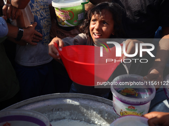 Displaced Palestinian children wait at a food distribution point in Deir el-Balah, Gaza Strip, on September 9, 2024, amid the ongoing confli...