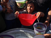 Displaced Palestinian children wait at a food distribution point in Deir el-Balah, Gaza Strip, on September 9, 2024, amid the ongoing confli...