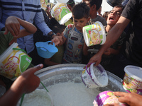 Displaced Palestinian children wait at a food distribution point in Deir el-Balah, Gaza Strip, on September 9, 2024, amid the ongoing confli...