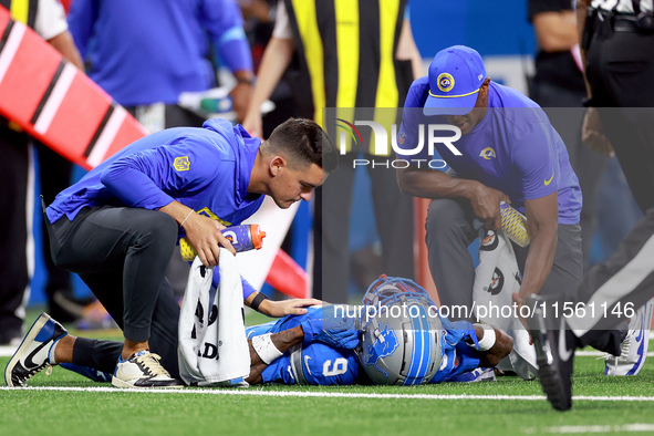 DETROIT,MICHIGAN-SEPTEMBER 8:  Wide receiver Jameson Williams (9) of the Detroit Lions is checked for injury during a game between the Detro...