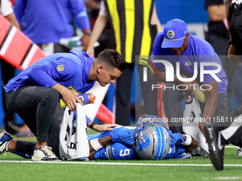 DETROIT,MICHIGAN-SEPTEMBER 8:  Wide receiver Jameson Williams (9) of the Detroit Lions is checked for injury during a game between the Detro...