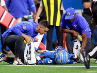 DETROIT,MICHIGAN-SEPTEMBER 8:  Wide receiver Jameson Williams (9) of the Detroit Lions is checked for injury during a game between the Detro...