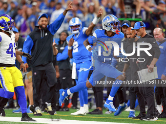 DETROIT,MICHIGAN-SEPTEMBER 8:  Wide receiver Jameson Williams (9) of the Detroit Lions runs the ball under the pressure of safety John Johns...