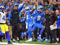 DETROIT,MICHIGAN-SEPTEMBER 8:  Wide receiver Jameson Williams (9) of the Detroit Lions runs the ball under the pressure of safety John Johns...