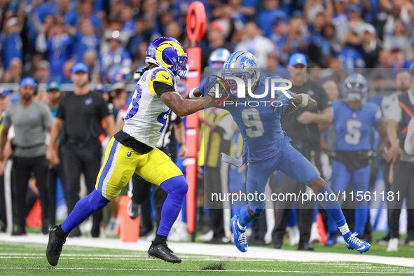 DETROIT,MICHIGAN-SEPTEMBER 8:  Wide receiver Jameson Williams (9) of the Detroit Lions runs the ball under the pressure of safety John Johns...