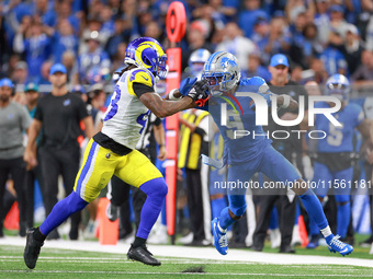 DETROIT,MICHIGAN-SEPTEMBER 8:  Wide receiver Jameson Williams (9) of the Detroit Lions runs the ball under the pressure of safety John Johns...