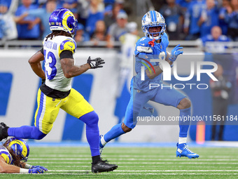 DETROIT,MICHIGAN-SEPTEMBER 8:  Wide receiver Jameson Williams (9) of the Detroit Lions runs the ball under the pressure of safety John Johns...