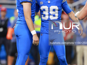 DETROIT,MICHIGAN-SEPTEMBER 8:  Detroit Lions place kicker Jake Bates is congratulated by punter Jack Fox (3) of the Detroit Lions after maki...