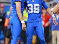 DETROIT,MICHIGAN-SEPTEMBER 8:  Detroit Lions place kicker Jake Bates is congratulated by punter Jack Fox (3) of the Detroit Lions after maki...