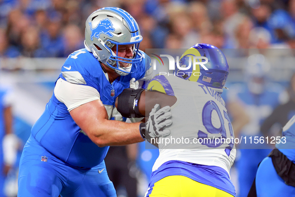 DETROIT,MICHIGAN-SEPTEMBER 8:  Defensive tackle Kobie Turner (91) of the Los Angeles Rams holds the line against guard Kevin Zeitler (71) of...