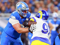 DETROIT,MICHIGAN-SEPTEMBER 8:  Defensive tackle Kobie Turner (91) of the Los Angeles Rams holds the line against guard Kevin Zeitler (71) of...