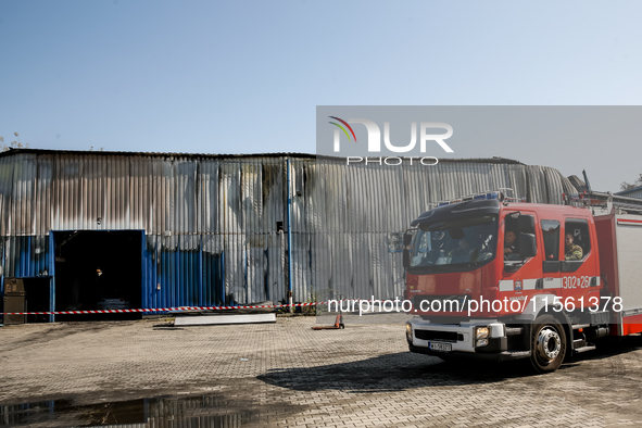 Firefighters are seen in front of a burned warehouse in southern Krakow as it burned in the night on September 7, 2024 in Krakow, Poland. Th...