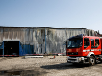 Firefighters are seen in front of a burned warehouse in southern Krakow as it burned in the night on September 7, 2024 in Krakow, Poland. Th...