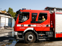 Firefighters are seen in front of a burned warehouse in southern Krakow as it burned in the night on September 7, 2024 in Krakow, Poland. Th...