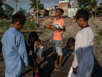 Kids play with kites near a polluted canal of the Buriganga River in Dhaka, Bangladesh, on September 9, 2024. (