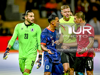 Georgia goalkeeper Luka Kharatishvili, Netherlands player Million Manhoef, referee Robert Schroder, and Georgia player Levan Osikmashvili du...