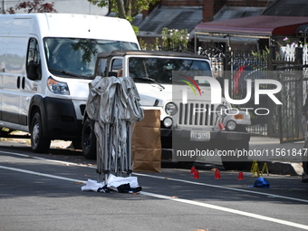 Crime scene investigators investigate the scene, place evidence markers, and search for clues after a 46-year-old male is shot multiple time...