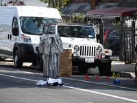 Crime scene investigators investigate the scene, place evidence markers, and search for clues after a 46-year-old male is shot multiple time...