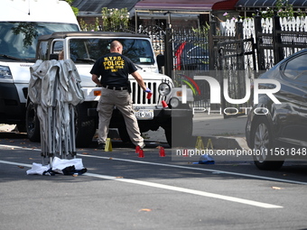 Crime scene investigators investigate the scene, place evidence markers, and search for clues after a 46-year-old male is shot multiple time...