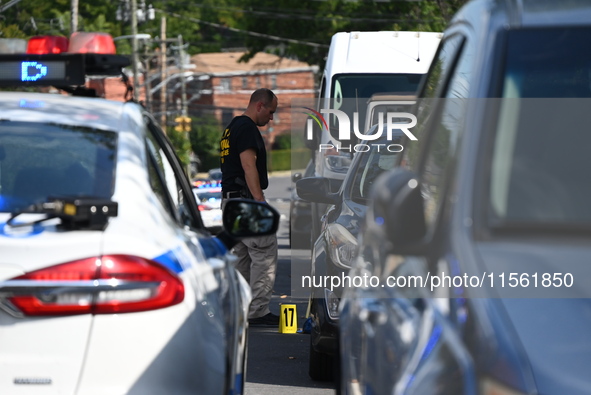 Crime scene investigators investigate the scene, place evidence markers, and search for clues after a 46-year-old male is shot multiple time...