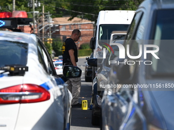 Crime scene investigators investigate the scene, place evidence markers, and search for clues after a 46-year-old male is shot multiple time...