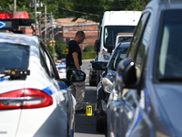 Crime scene investigators investigate the scene, place evidence markers, and search for clues after a 46-year-old male is shot multiple time...